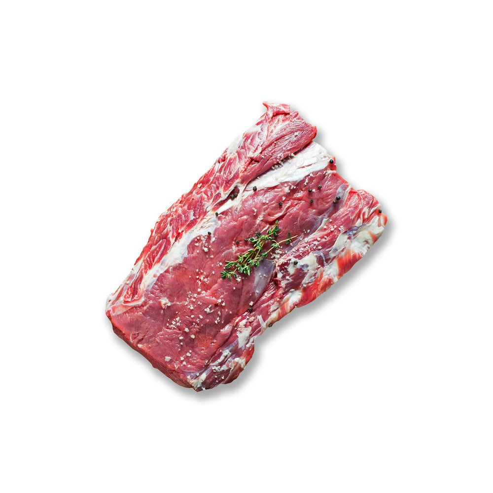 Whole Kentucky grass-fed Rose Veal brisket seasoned with coarse salt and fresh thyme, ideal for smoking, roasting, or braising.